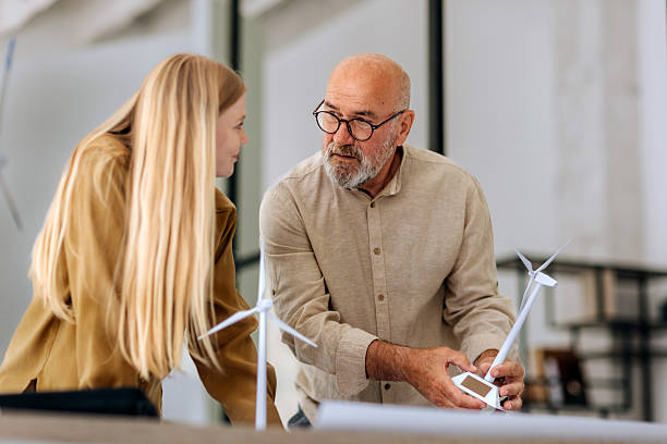 istock Professionals reviewing wind turbine design in office setting 2223352181