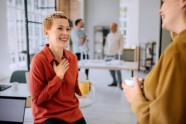 istock Two smiling female colleagues talking during coffee break at the office 2223352323