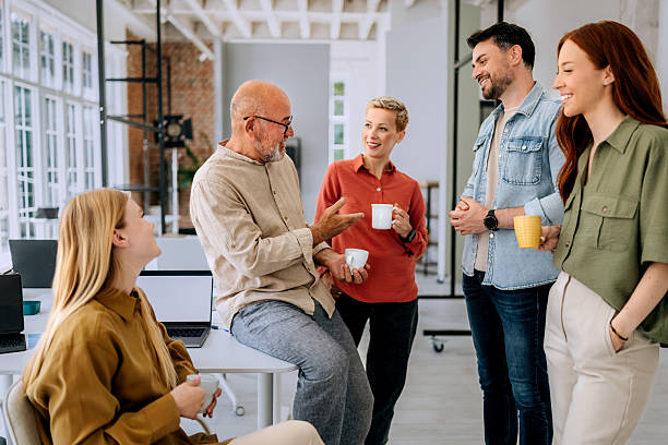istock Group of colleagues having coffee break at the office 2223352357