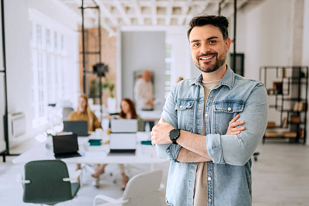 istock Cheerful casually clothed young businessman posing for camera at the office 2223352372