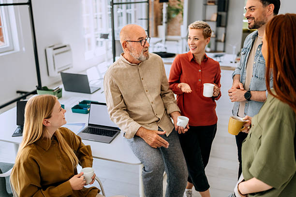 Group of colleagues having coffee break at the office