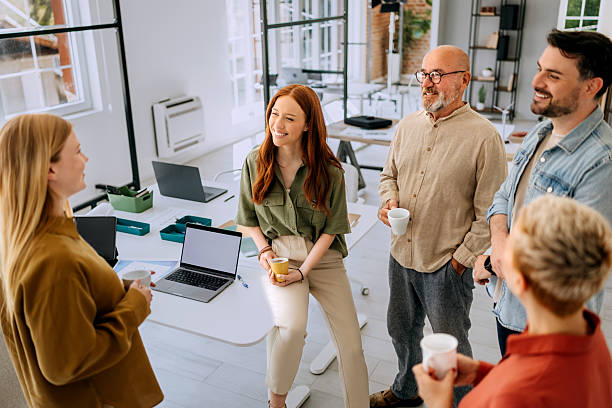 istock Group of colleagues having coffee break at the office 2223352393