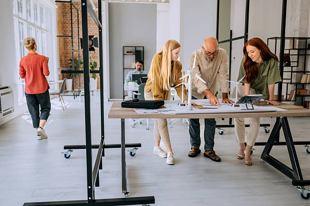 istock Three colleagues working on turbine model project in office 2223352487