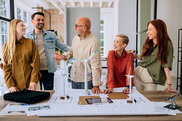 istock Group of colleagues working on wind turbine models at office 2223352541
