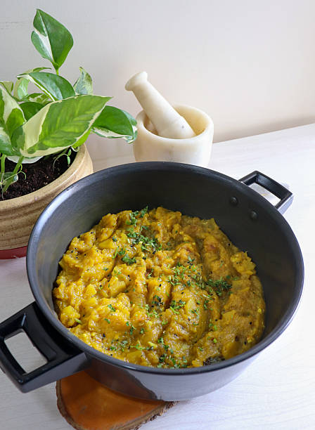 Sweet and tangy Pumpkin Oambal or chutney made with red pumpkin, jaggery, raw mango, onion seeds, garlic, chili, and curry leaves. A traditional Maharashtrian dish, perfect for a festive thali meal.