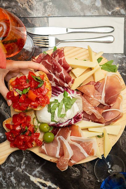 istock Cutting board with salami, mozzarella and bruschetta at a restaurant table 2223354211