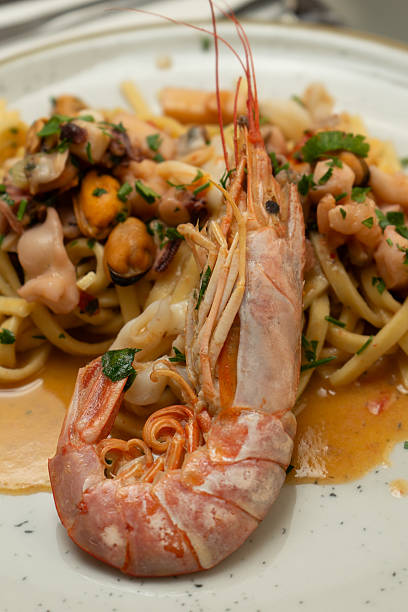 istock Spaghetti with seafood and shrimp at a restaurant table 2223354247