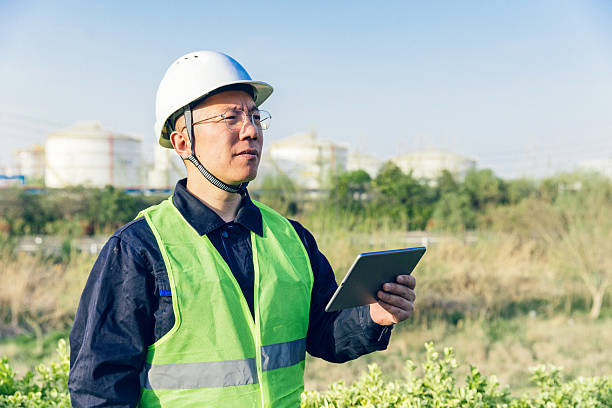 istock Male engineer using digital tablet while working in oil and gas industry, refinery. 2223354250