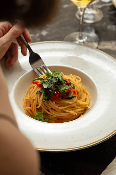 istock Spaghetti with tomato sauce at a restaurant table 2223354261
