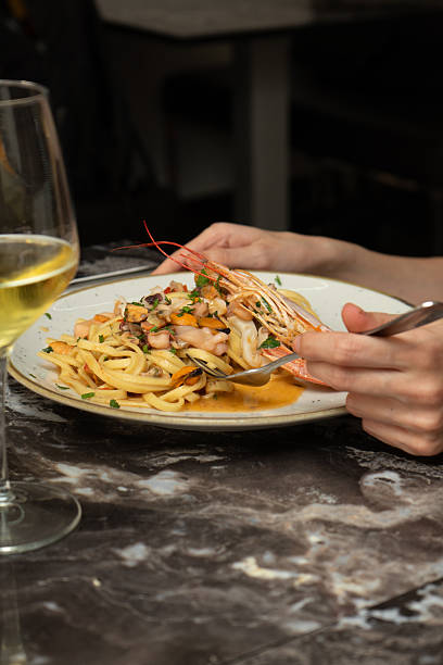 istock Spaghetti with seafood and shrimp at a restaurant table 2223354272