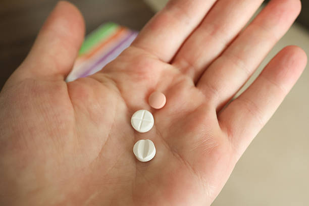 istock Organizing Pills in Weekly Medication Box 2223354760