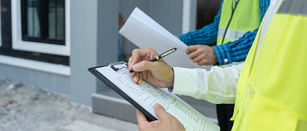 istock inspector or engineer is inspecting construction and quality assurance new house using a checklist. Engineers or architects or contactor work to build the house before handing it over to the homeowner 2223354879