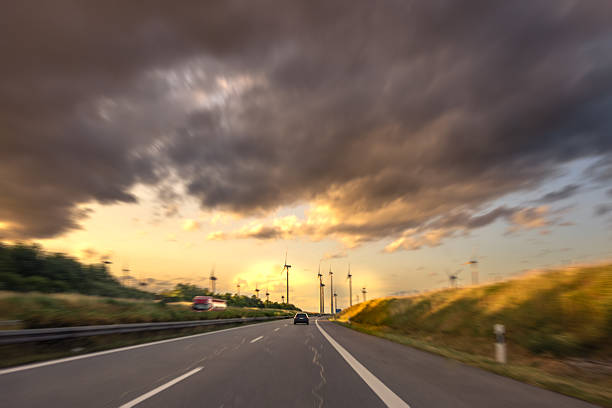Long exposure of cars on a highway with four lanes.