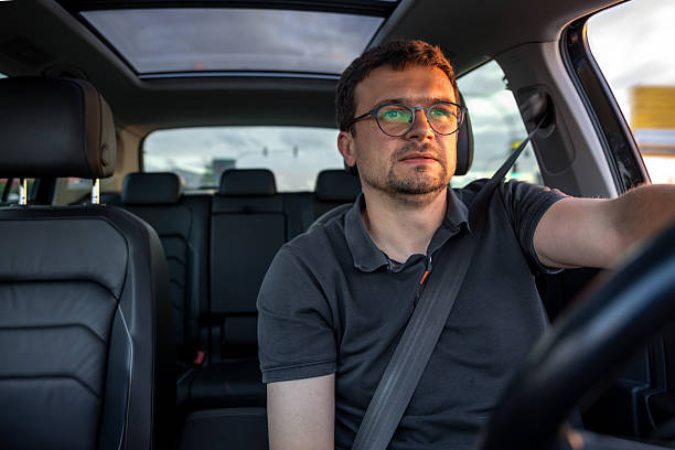 istock Man driving car. Driver in modern vehicle. Safe driving concept. 2223355223
