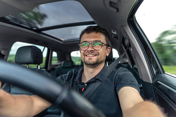 istock Smiling driver on the move. Joy of driving. Modern car interior. 2223355232