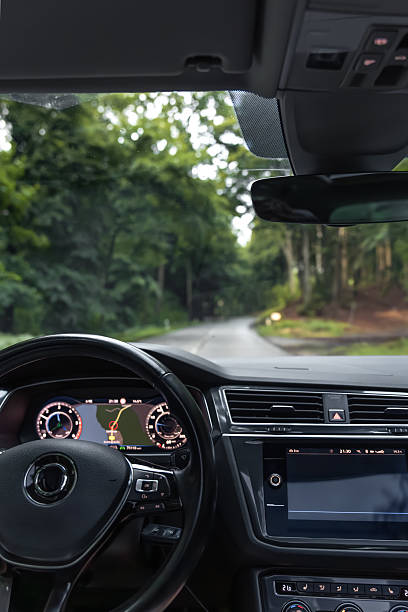 istock Vertical view from car. Forest road ahead. GPS and travel route. 2223355235