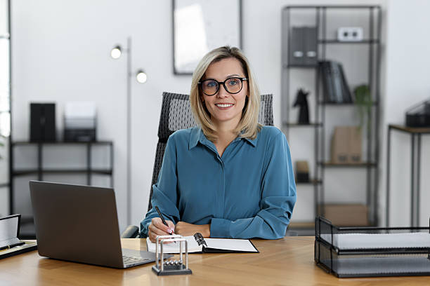 istock Happy businesswoman working at table in office 2223355434