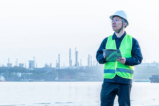 istock Engineer working with clipboard outside chemical plant 2223358330