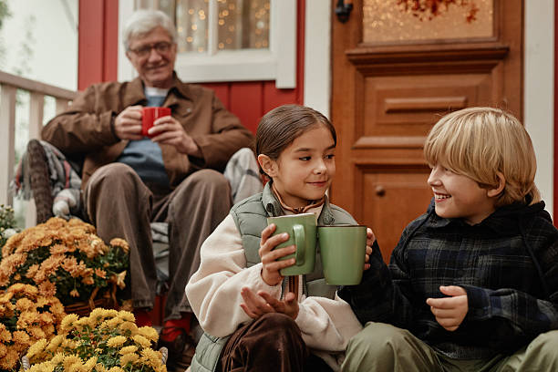 istock Caucasian Grandfather Watching Grandchildren Laughing While Drinking Warm Beverages 2223359909