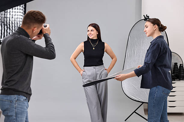 istock Photographer and assistant working with model in professional photo studio 2223361992