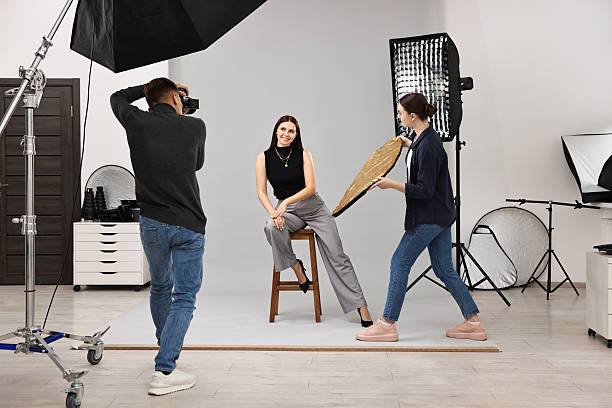istock Photographer and assistant working with model in professional photo studio 2223362035