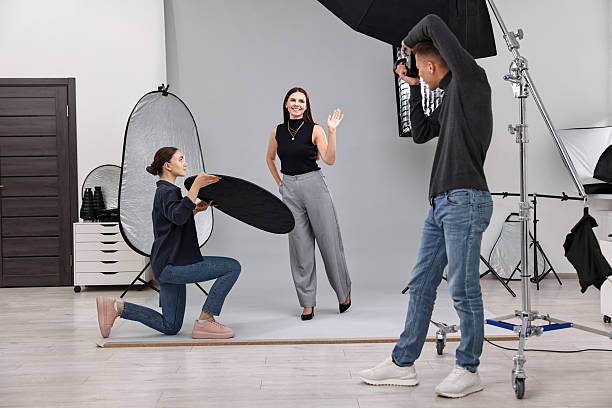 istock Photographer and assistant working with model in professional photo studio 2223362051