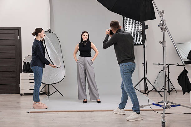 istock Photographer and assistant working with model in professional photo studio 2223362070
