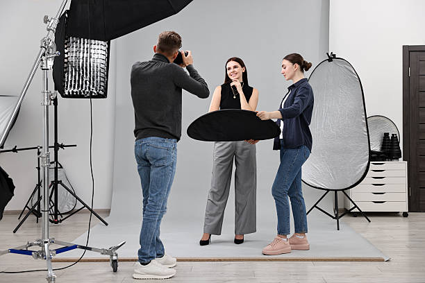 istock Photographer and assistant working with model in professional photo studio 2223362146