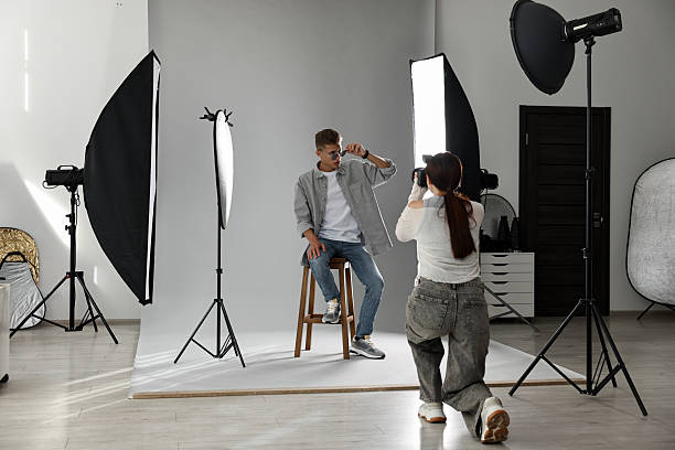 istock Photographer working with model in professional photo studio 2223362159