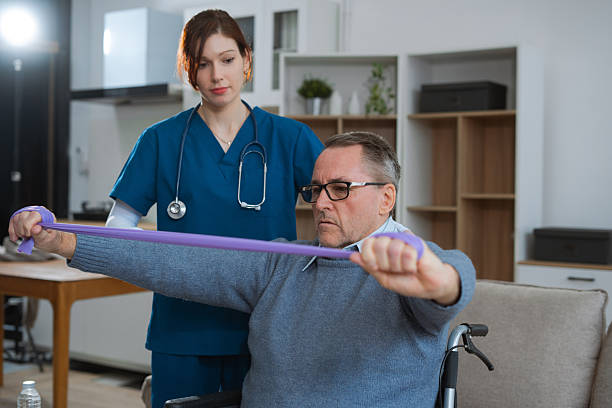 istock senior man doing exercise at clinic with physiotherapist. help of a therapist trainer during a rehabilitation session. 2223362597