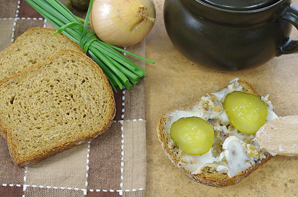 slice of bread with lard on stone background