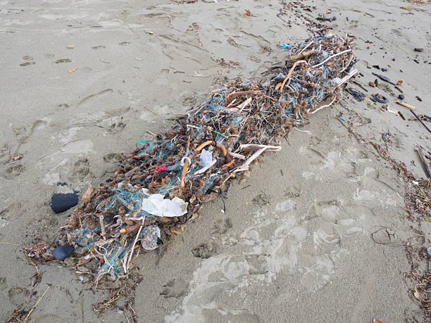 fishing net arrived on the beach full of plastic waste. Symbol fo ocean pollution. Danger fo marine life
