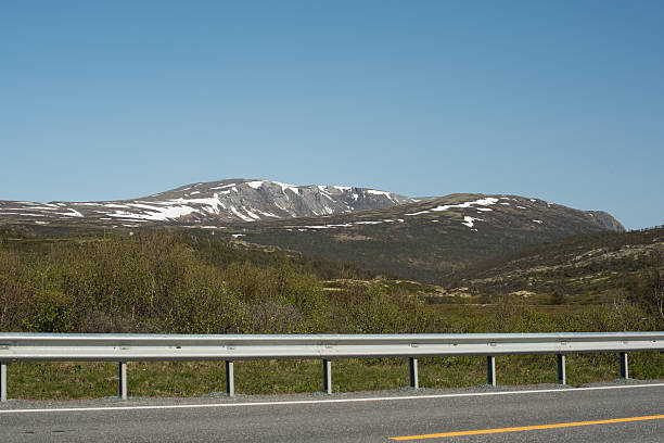 istock Road through the snowy mountain in Norway 2223367267