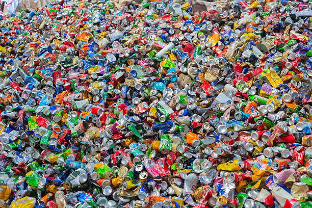 Colorful crushed cans forming a large pile of recyclable aluminum waste