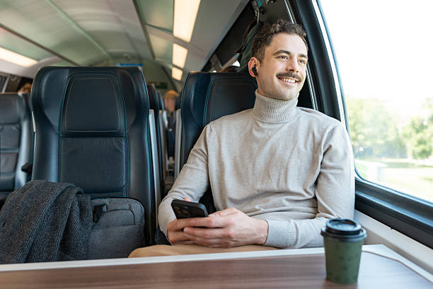 istock A man enjoys the view on a peaceful train ride 2223379336