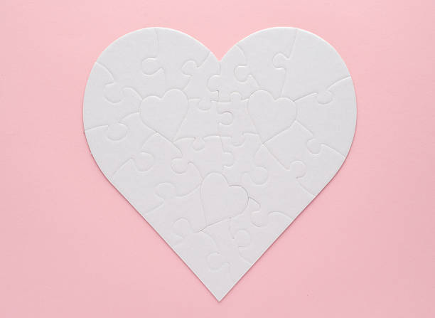 istock White heart-shaped jigsaw puzzle on a pink background. Symbolizing love, connection, and unity, this minimalist design is perfect for themes of relationships, teamwork, and problem-solving. 2223384725