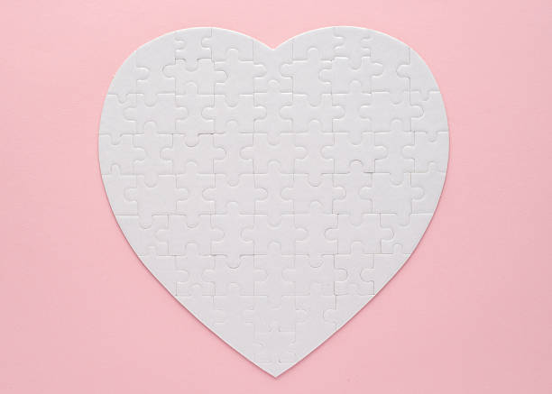 istock White heart-shaped jigsaw puzzle on a pink background. Symbolizing love, connection, and unity, this minimalist design is perfect for themes of relationships, teamwork, and problem-solving. 2223384732