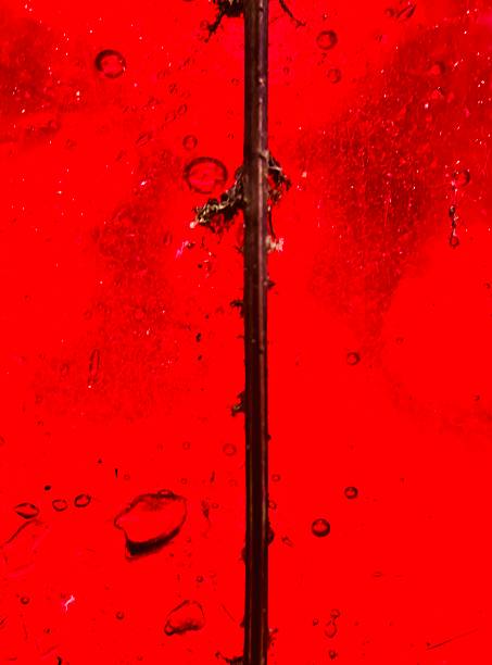 A closeup of red stained glass lead seem.