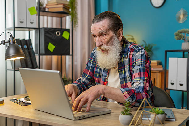 istock Frustrated senior man having software problems with laptop, angry man get nervous seeing error virus 2223391905