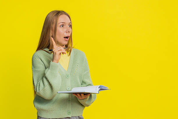 istock Woman making notes writing down thoughts with pen into notepad notebook diary to do list good idea 2223392383