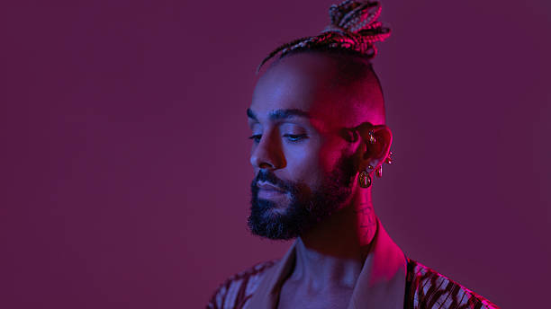 istock Neon light studio close-up portrait handsome black gay man looking camera. 2223392866