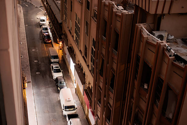 Elevated perspective of a narrow street with parked cars nestled between buildings in Downtown Dubai.