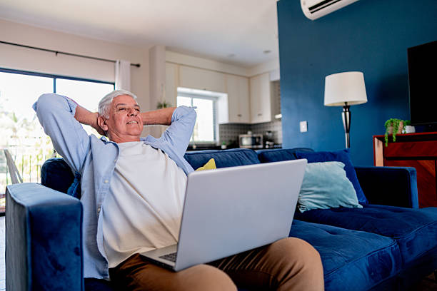istock Happy senior man using laptop at home 2223394494