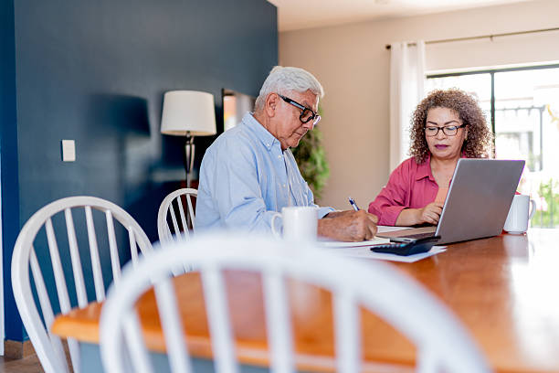 istock Senior couple talking and doing home finance 2223395560