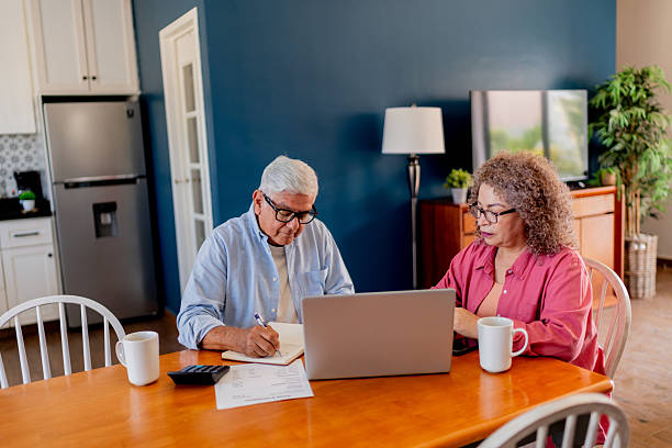 istock Senior couple talking and doing home finance 2223395583