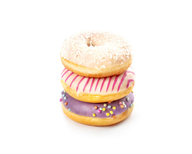 istock Delicious stack of colorful donuts with sprinkles and frosting on a bright white background 2223396885