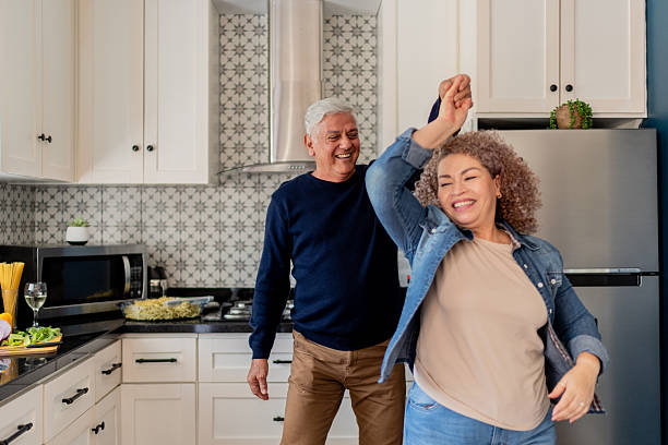 Senior couple dancing on kitchen at home