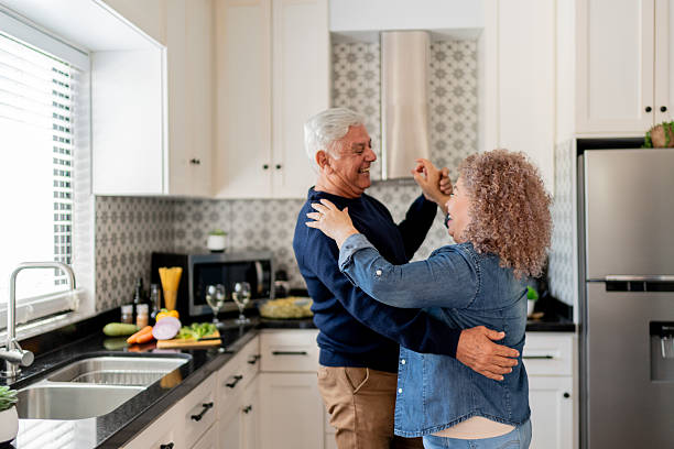 istock Senior couple dancing on kitchen at home 2223398325