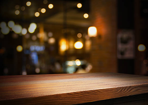 istock Empty wooden table with bokeh and blur restaurant background. 2223400469
