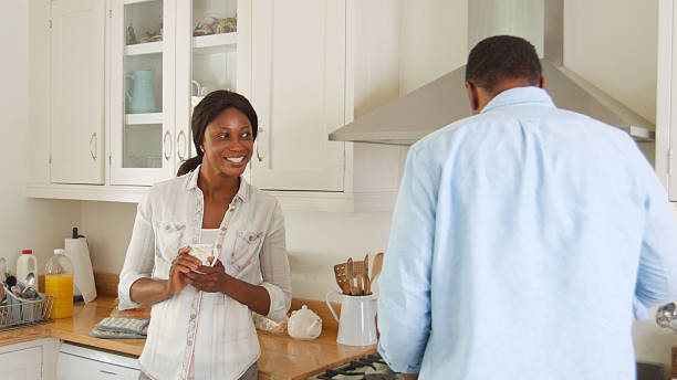 istock Mature Couple Chat In Kitchen As Man Prepares Meal In Kitchen 2223400705